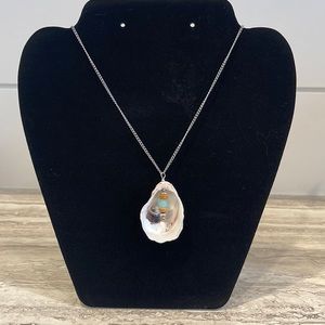 Handmade Necklace with Seashell Charm with aqua, wood,and silver beads.